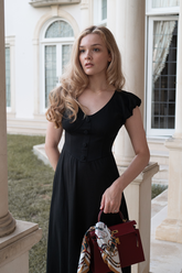 a lady wears a black lace sequins crop jacket with a matching slit skirt